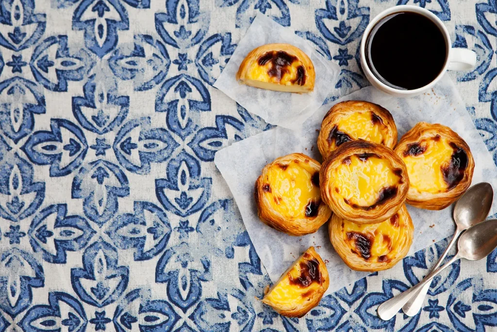 pastel de nata with espresso on traditional Portuguese azulejo tiles